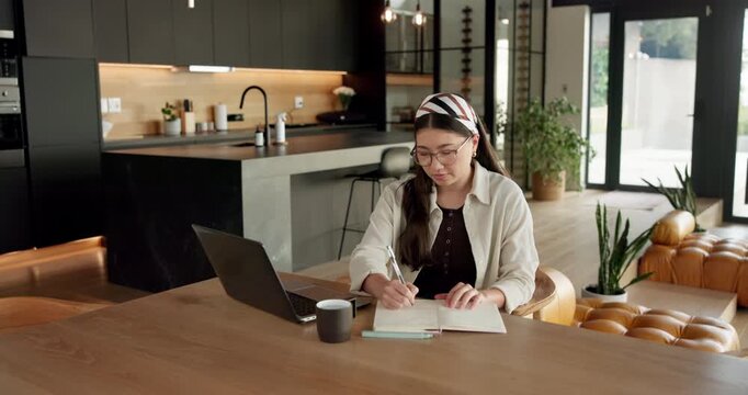 Student, woman and writing in home with laptop, diary or test schedule for distance learning college. Asian person, notes and reminder with computer, online education or exam calendar for university.