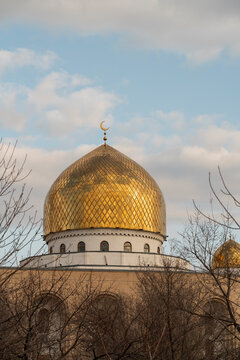 Golden mosque dome in Uzbekistan under cloudy sky