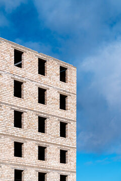 Unfinished brick building facade against blue sky in Uzbekistan