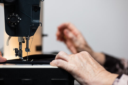 Senior hands sewing a homemade garment with care
