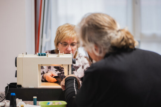 Senior women sewing together in a cozy workspace