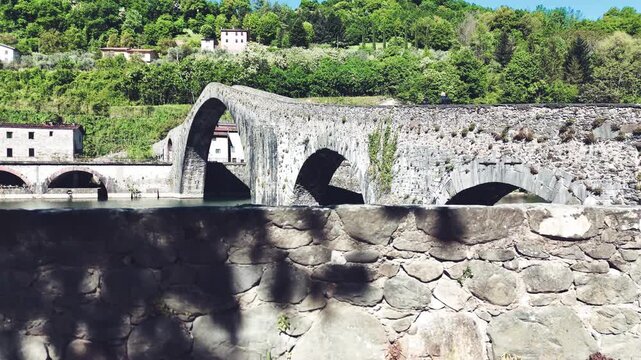 Aerial view of Devil's Bridge Ponte della Maddalena Borgo a Mozzano over Serchio River Tuscany Italy