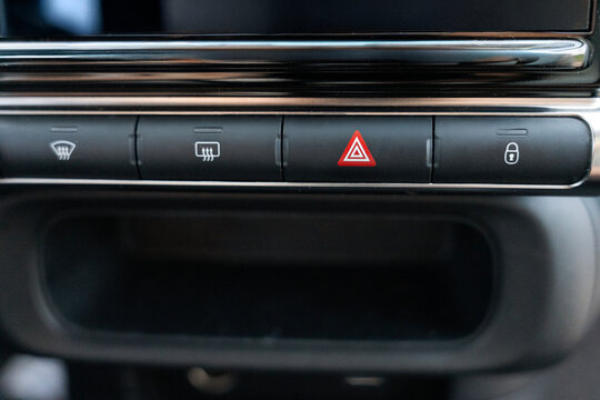 Car dashboard control panel with hazard warning button