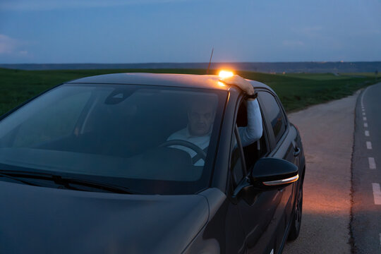 V16 emergency beacon warning on car during roadside stop