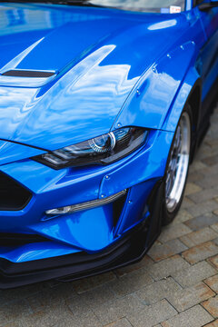 Sleek blue sports car with aggressive styling