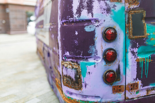 Close-up of vibrant rusty van with weathered paint