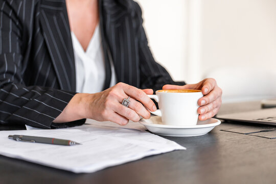 Businesswoman enjoying a coffee at her desk
