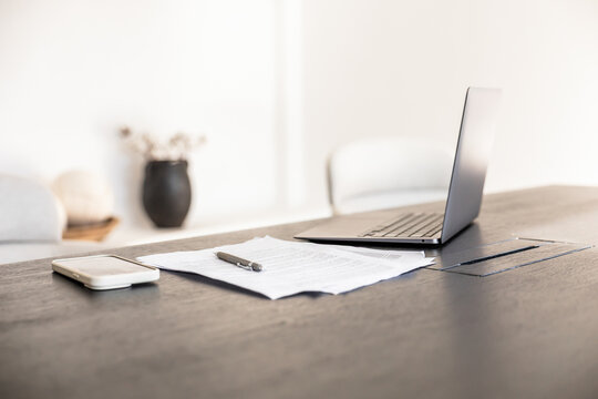 Modern office workspace with laptop and documents