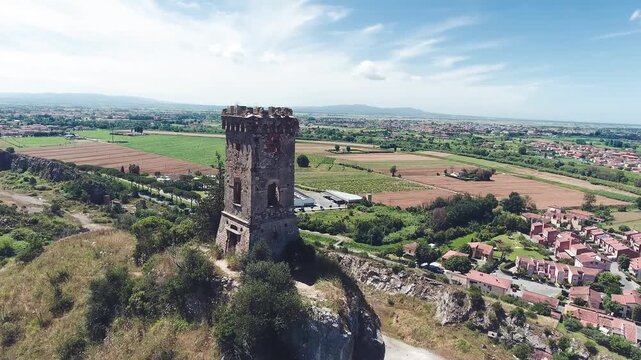 Aerial view of medieval tower on the top of the mountain. Drone viewpoint. Slow motion
