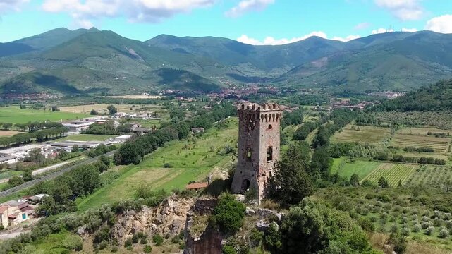 Caprona, Tuscany. Aerial view of famous medieval tower on the mountain top. Slow motion
