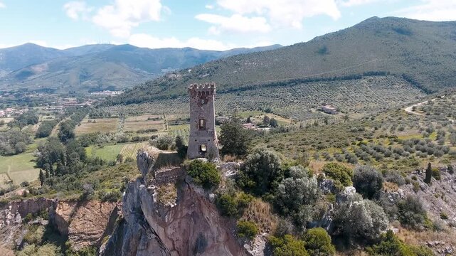Aerial view of medieval tower on the top of the mountain. Drone viewpoint. Slow motion