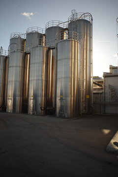 Industrial Silos with Golden Reflections at Sunset