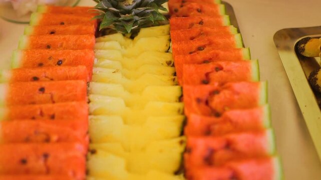 Fresh watermelon and pineapple slices arranged on a tray