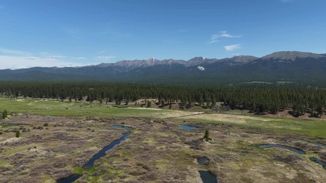 Aerial of Phillips Lake in Oregon with snow capped peaks in Wallowa Mountains