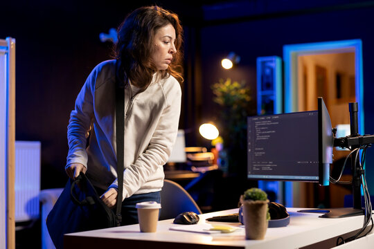 System administrator arriving in office, ready to design and develop software applications on laptop. IT expert starting job shift, unpacking notebook, implementing and maintaining company systems