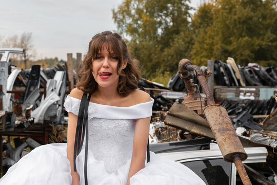 Bride on car junkyard