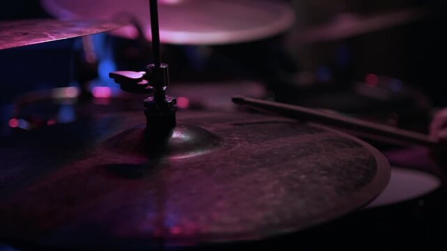 Spinning vinyl record on a turntable in moody blue light