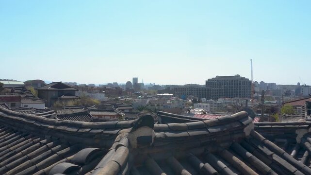 Bukchon Hanok Village roofs and Seoul, South Korea skyline. Horizontal panning footage