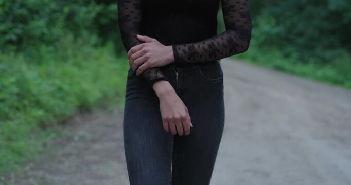 Woman walking alone with a nervous and insecure posture, appearing anxious, shy, and intimidated. Concept of fear, vulnerability, social anxiety, insecurity, and emotional distress.