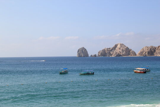 tour boats navigating the waters near land's end in cabo san lucas mexico