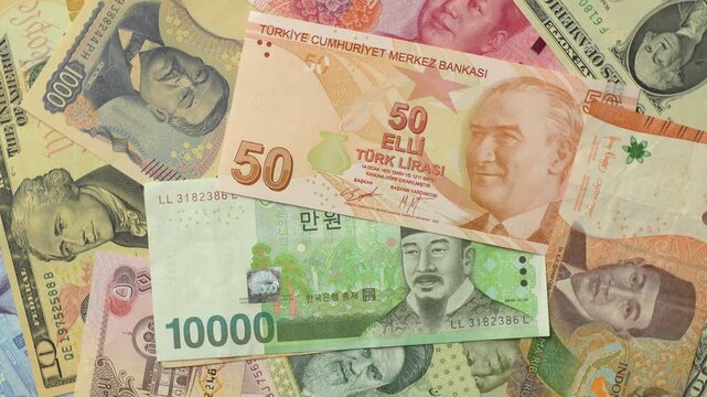 World international banknotes rotating footage. Chinese Yuan, Korean Won, Indonesian Rupiah, Turkish Lira, Japanese Yen, Iranian Rial, USD. Business currency finance background