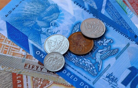 Trinidad and Tobago dollar money bills and coins on table. Trinidad and Tobago cash of TTD currency