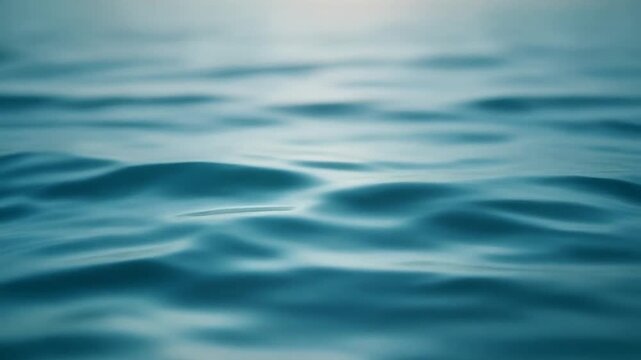 Calm ocean waves gently ripple on the serene surface of the water