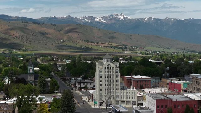Aerial of Baker Tower in Baker City small town in eastern Oregon in spring with snow capped peaks