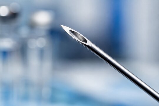 Close Up of Hypodermic Needle with Blurred Medical Laboratory Background