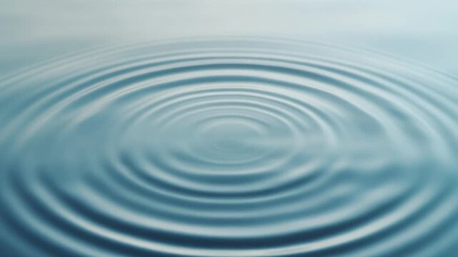 Soft blue water ripples creating peaceful concentric circles on a calm surface