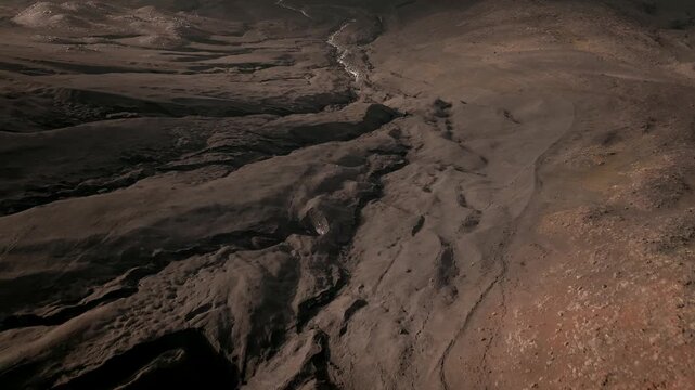 Drone footage over Tolbachinsky Dol lava fields with rugged volcanic terrain, ash and basalt textures, and erosion channels in Kamchatka Krai, Russia