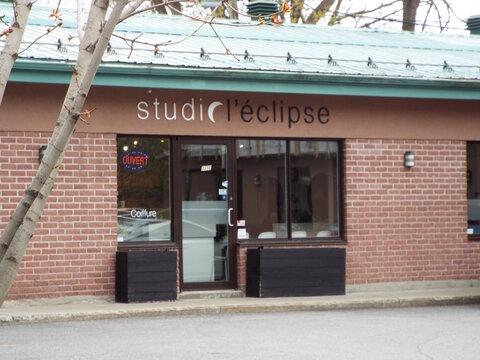Gatineau, Quebec, Canada &ndash; May 8, 2026: The storefront of "Studio L&rsquo;&eacute;clipse" features a brick exterior, a glass entrance, and an open sign for hairdressing at 379 Boul. Alexandre-Tach&eacute;.