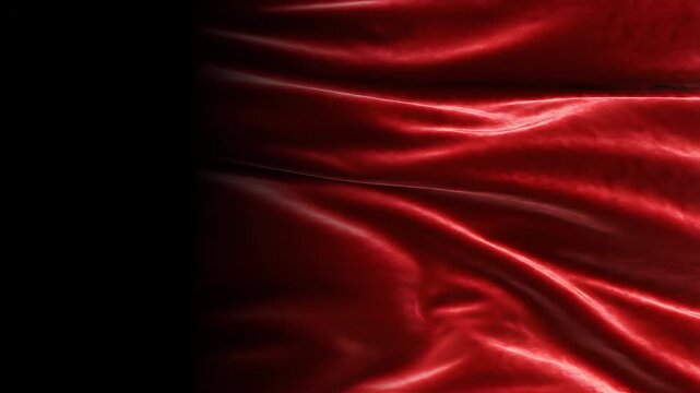 Elegant red silk fabric waving on black background