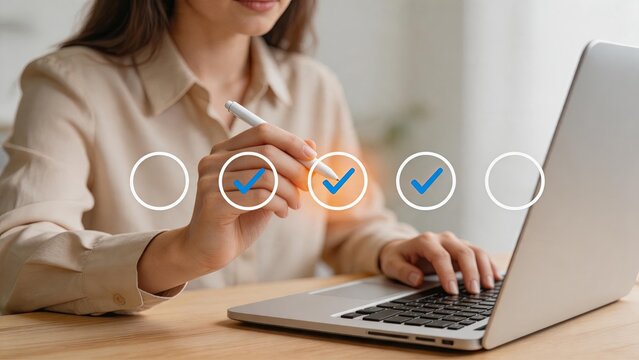 Woman completing online survey checklist on laptop computer with digital checkmarks, customer feedback and user experience evaluation concept
