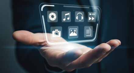 Obraz premium Hand holding futuristic holographic interface displaying digital media and technology icons