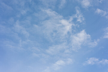Obraz premium Wispy White Clouds Floating Through Blue Sky