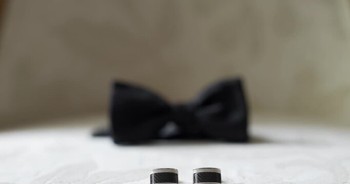 Blurred black bow tie on a white surface