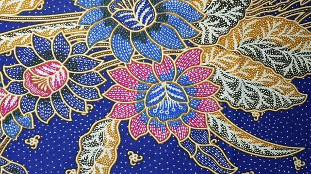 Stop motion of various colorful floral batik fabric patterns alternating. Traditional textile art background for fashion.