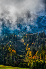 Obraz premium Zugspitze Cable Car Through Misty Alpine Forest