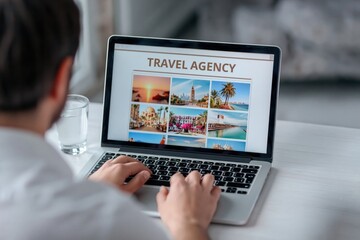 Man booking vacation on laptop website at travel agency desk person planning holiday
