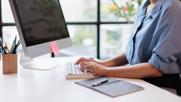 Crop famale employee typing on computer keyboard document financial report, business plan investment, finance analysismanagement concept 
