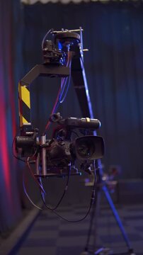 Professional broadcasting camera crane moving in a television studio