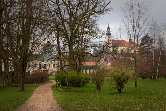 Park path leading to historic European church and Schloss