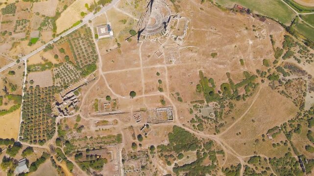 Balat, Turkey. Ancient Miletus ruins with the Great Theatre and Ilyas Bey Mosque complex, aerial view over the archaeological site on a dry summer day. Aerial View, HEAD OVER SHOT