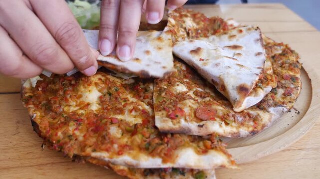 Preparing and Eating Traditional Turkish Lahmacun with Fresh Lettuce