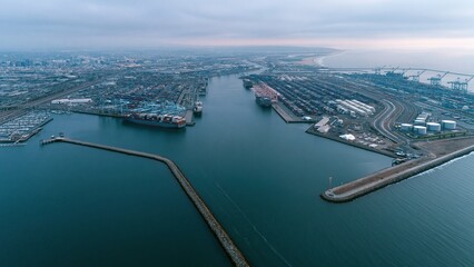 Obraz premium Aerial view of a river harbor with docks and container terminals at