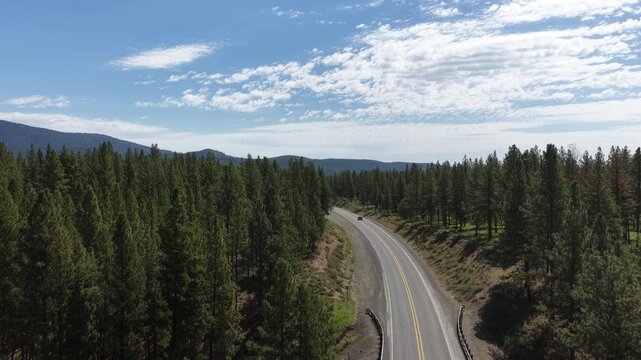 Aerial over highway 7 near Phillips Lake in East Oregon in pine tree forest in spring