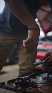 close up of a hand holding a car engine