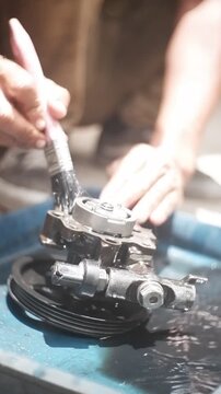 close up of a hand holding a car engine