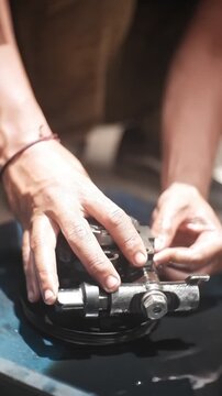 close up of a hand holding a car engine